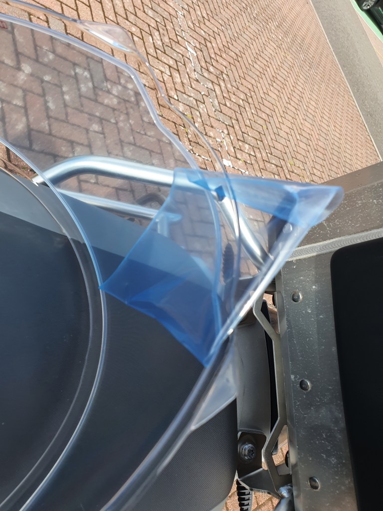Close up image of removal of film from safety helmet visor insert